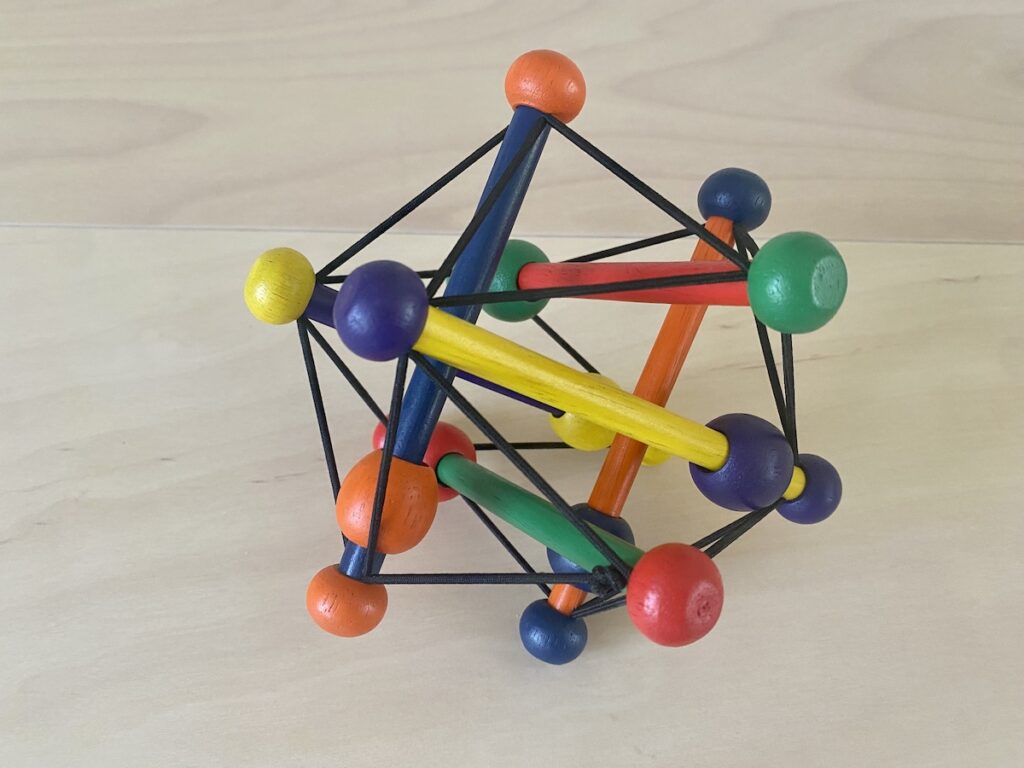 A brightly colored classic skwish rattle
